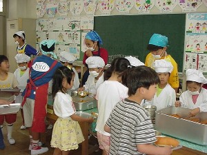 １年生の給食のはいぜんを手伝っています